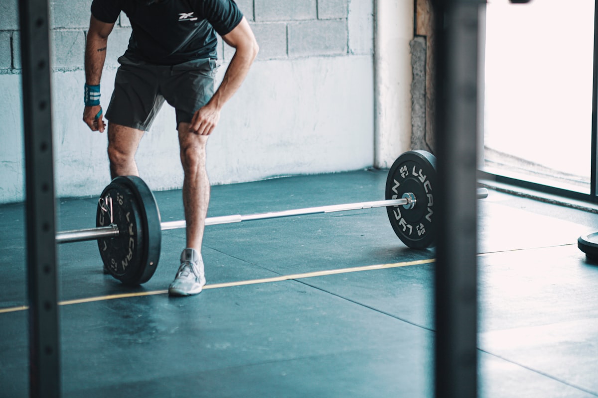 Men's fitness training setup with weights and resistance equipment